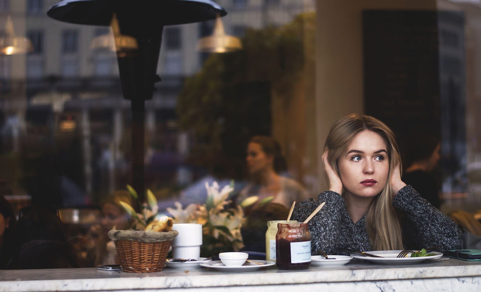 Woman wondering if she should freeze her eggs while staring out the window