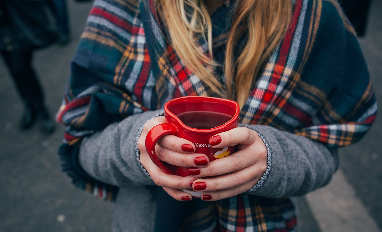 woman holding coffee during flu season