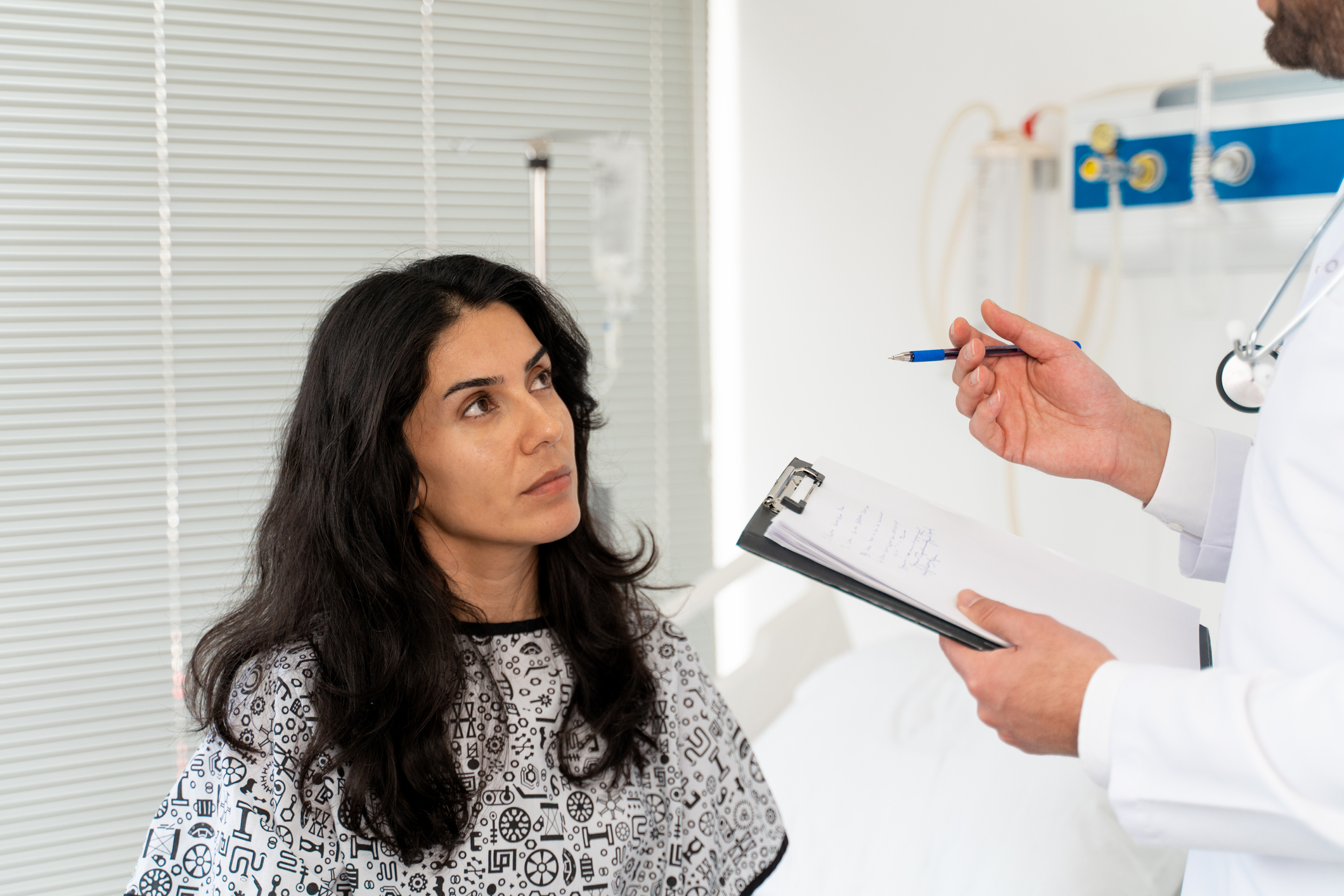 woman with cancer talking to doctor about infertility and fertility preservation